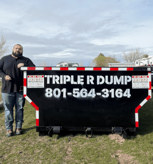 Joseph Rodrigues beside a 15 yard Triple R Dump roll-off bin