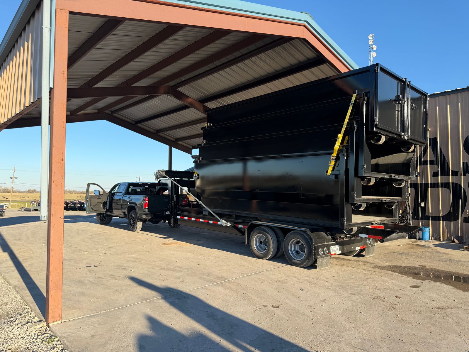 Triple R Dump dump trailer under a covered loading area